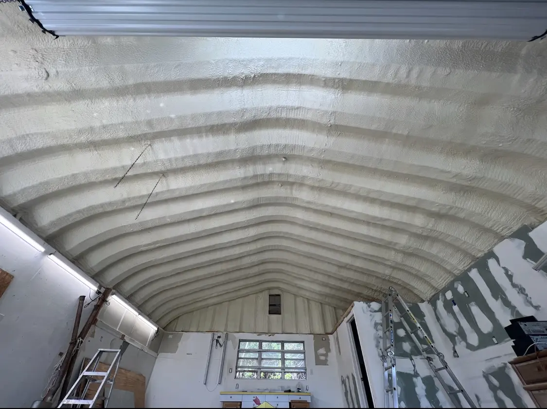 Spray polyurethane foam applied to the underside of a metal roof deck in Sandown
